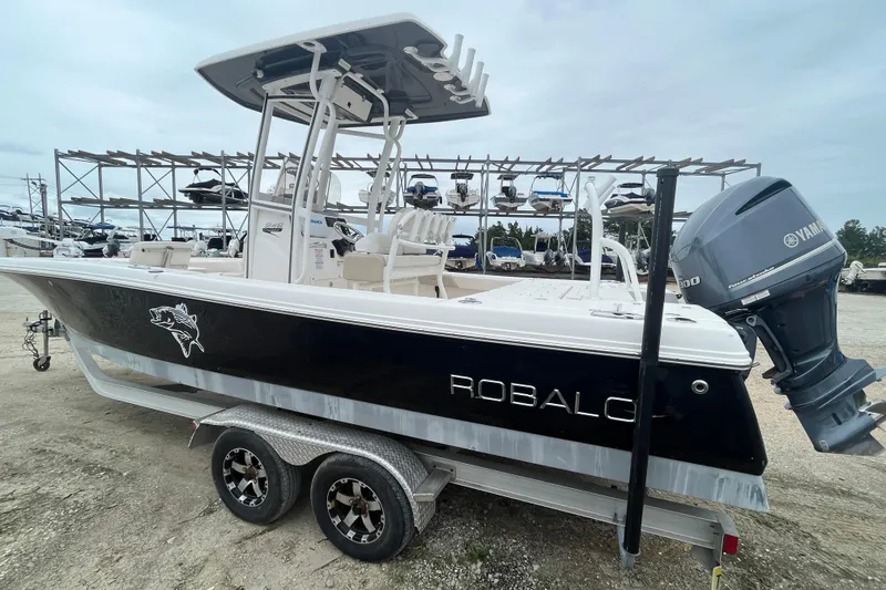 Slide: The Image of 2016 Robalo 246 Cayman boat with Yamaha engine on trailer, parked in marina. - 3
