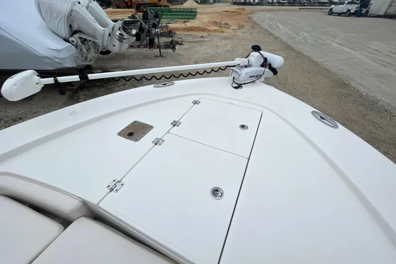 Slide: The Image of 2016 Robalo 246 Cayman boat deck with trolling motor in a storage yard. - 30