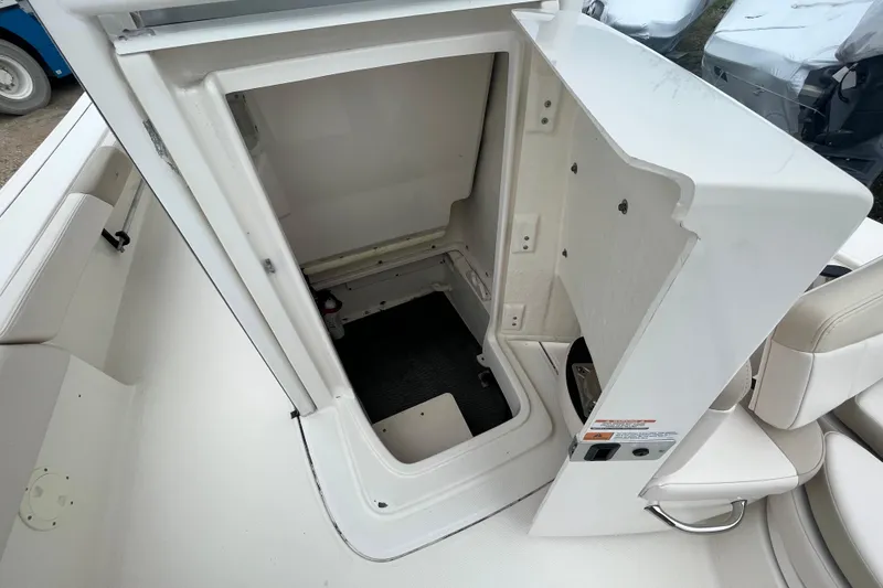 Slide: The Image of 2016 Robalo 246 Cayman boat storage compartment with open hatch, showcasing interior space. - 32