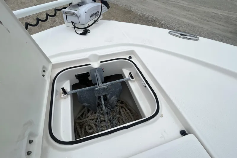 Slide: The Image of Anchor storage compartment on 2016 Robalo 246 Cayman boat with Minn Kota trolling motor. - 35
