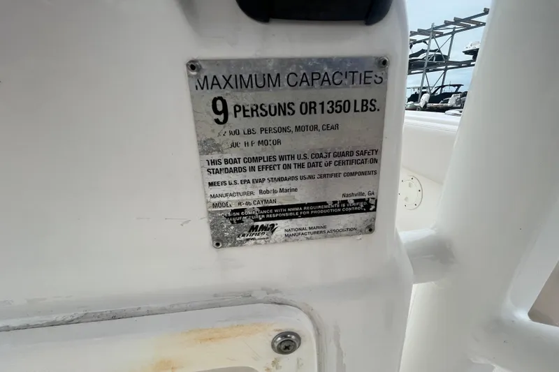 Slide: The Image of 2016 Robalo 246 Cayman capacity plate, maximum 9 persons or 1350 lbs. - 38
