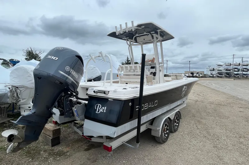 Slide: The Image of 2016 Robalo 246 Cayman boat with Yamaha 300 engine on trailer, parked outdoors. - 5