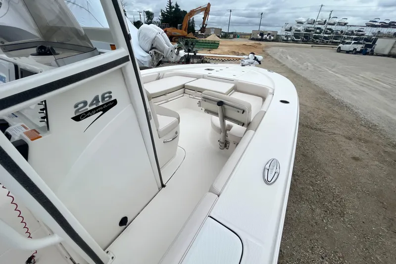 Slide: The Image of 2016 Robalo 246 Cayman boat, white interior, parked on gravel lot. - 9
