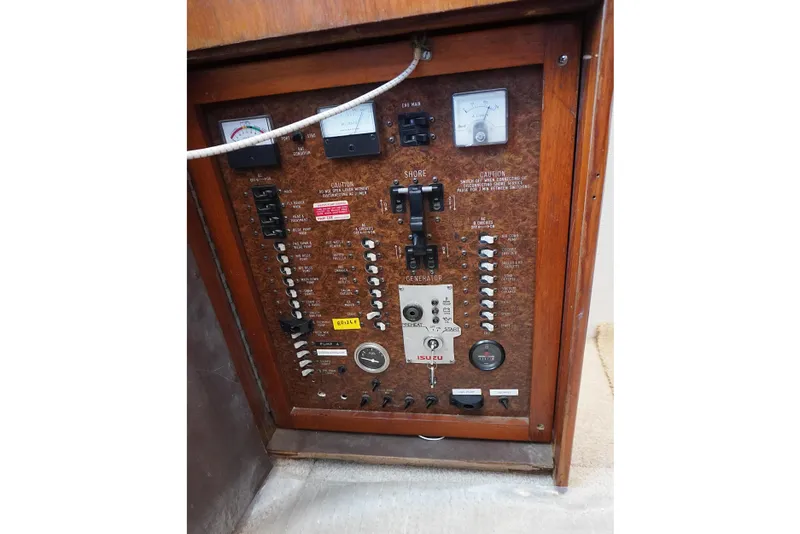 Slide: The Image of Electrical panel of a 1986 Ocean Yachts 38 Super Sport boat, featuring various switches and gauges. - 13