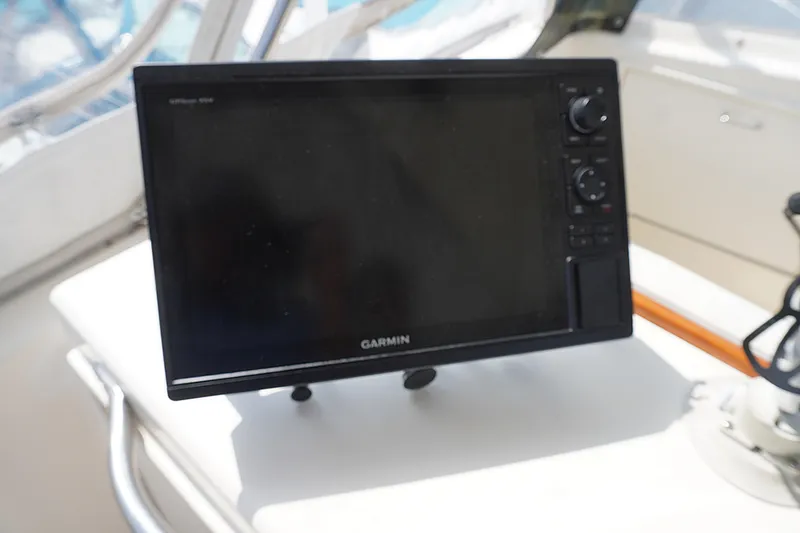 Slide: The Image of Garmin GPS device on 1986 Ocean Yachts 38 Super Sport boat dashboard. - 19