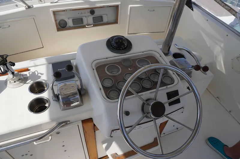 Slide: The Image of 1986 Ocean Yachts 38 Super Sport helm with steering wheel and control panel. - 20