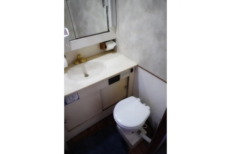 Slide: The Image of Bathroom interior of 1986 Ocean Yachts 38 Super Sport with sink and toilet. - 25
