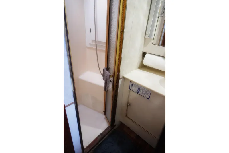 Slide: The Image of Shower area in 1986 Ocean Yachts 38 Super Sport, featuring compact design and amenities. - 26