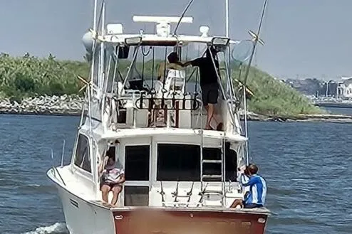 Slide: The Image of 1986 Ocean Yachts 38 Super Sport cruising with passengers on a sunny day. - 3