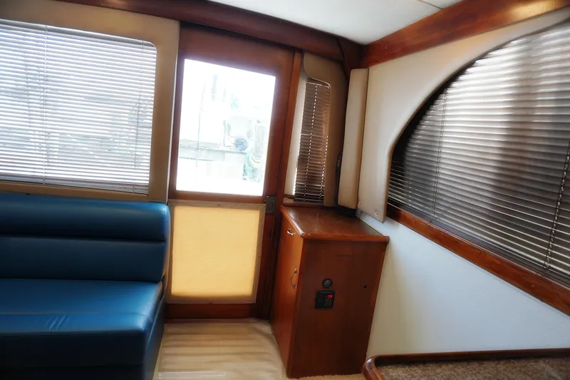 Slide: The Image of Interior of 1986 Ocean Yachts 38 Super Sport with blue seating and wooden accents. - 9