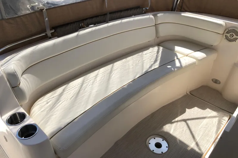 Slide: The Image of 2004 Rinker Fiesta Vee 312 boat interior with beige seating and cup holders. - 11