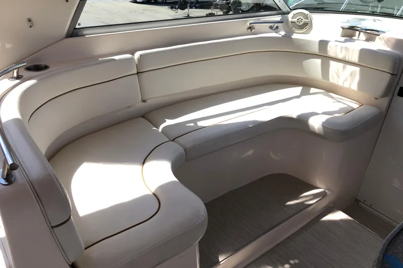 Slide: The Image of 2004 Rinker Fiesta Vee 312 boat interior with white cushioned seating. - 12