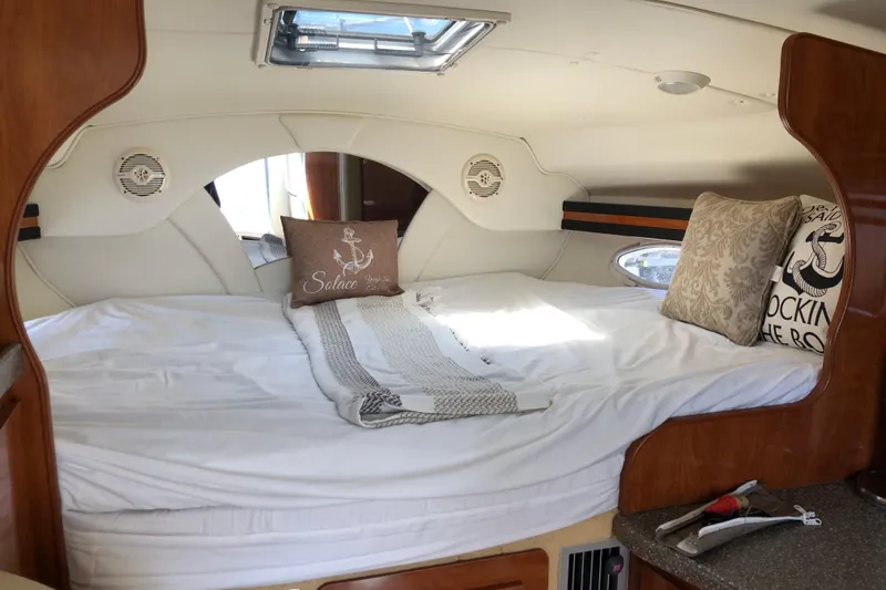 Slide: The Image of Cozy cabin interior of 2004 Rinker Fiesta Vee 312 with plush bedding and decorative pillows. - 20