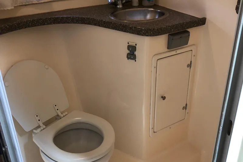Slide: The Image of 2004 Rinker Fiesta Vee 312 boat bathroom with toilet and sink. - 22