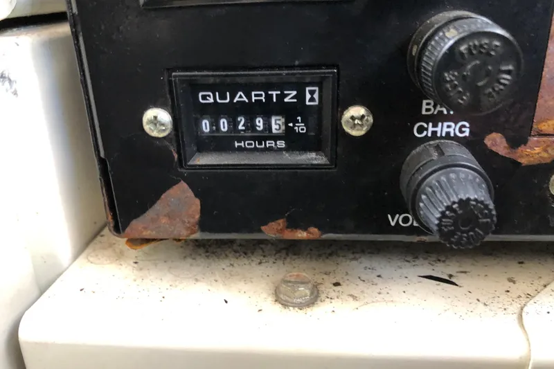 Slide: The Image of Rinker Fiesta Vee 312 2004 hour meter showing 295 hours with rust and controls. - 27