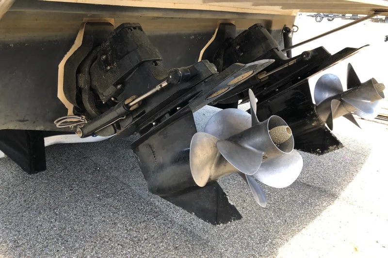 Slide: The Image of 2004 Rinker Fiesta Vee 312 boat propellers and outdrives on display. - 6