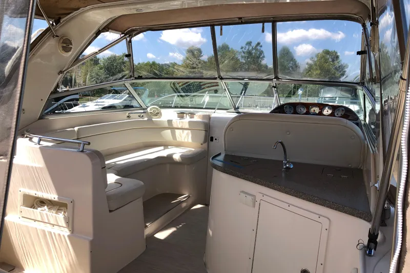 Slide: The Image of 2004 Rinker Fiesta Vee 312 boat interior with seating and control panel. - 9