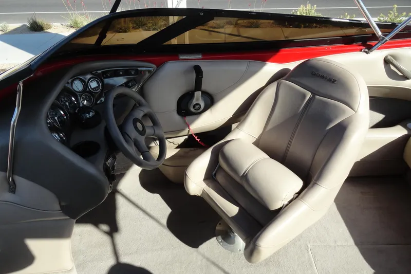 Slide: The Image of Interior of a 2000 Crownline 202 BR LPX boat, featuring steering wheel and dashboard. - 11