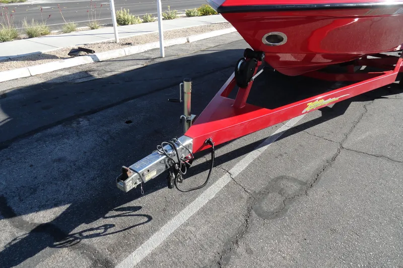 Slide: The Image of Red 2000 Crownline 202 BR LPX boat on trailer, parked on asphalt. - 19