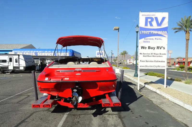 Slide: The Image of Red 2000 Crownline 202 BR LPX boat parked near RV sales and service center. - 20