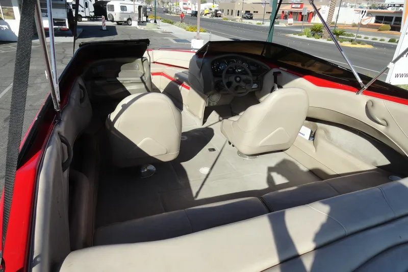 Slide: The Image of Interior of a 2000 Crownline 202 BR LPX boat with beige seating and red accents. - 6