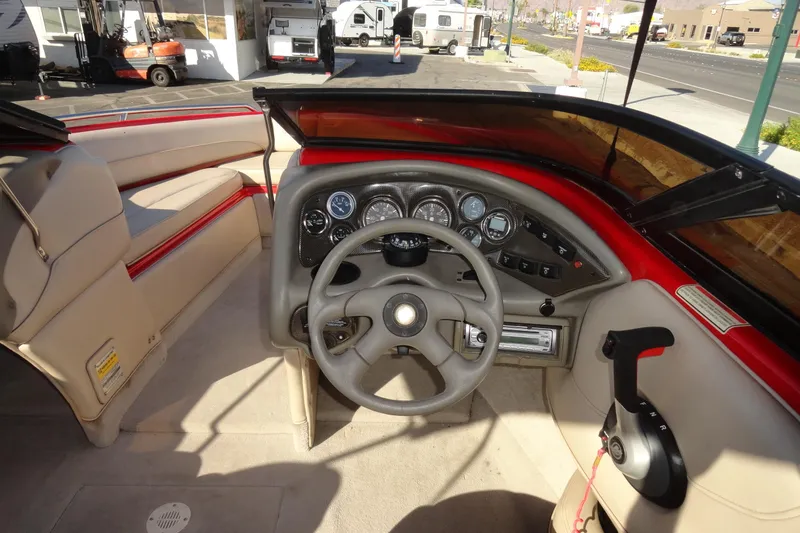 Slide: The Image of Interior view of a 2000 Crownline 202 BR LPX boat dashboard and steering wheel. - 7