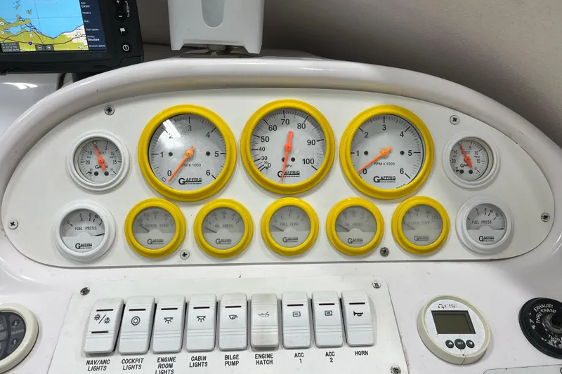 Slide: The Image of Dashboard of a 1999 Donzi 28 ZX boat with gauges and controls. - 12