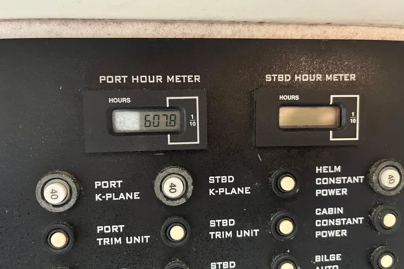 Slide: The Image of Control panel of a 1999 Donzi 28 ZX boat showing hour meters and switches. - 15
