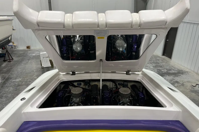 Slide: The Image of 1999 Donzi 28 ZX boat engine compartment with open hatch in a garage setting. - 16