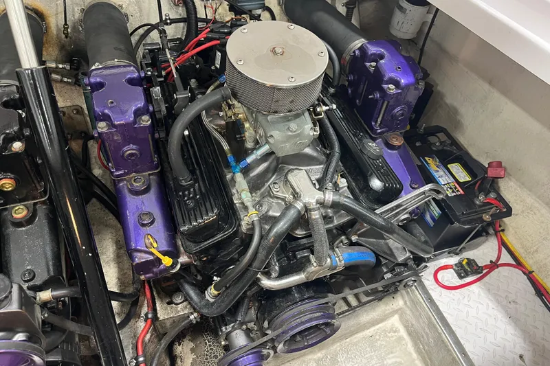 Slide: The Image of Engine of a 1999 Donzi 28 ZX boat with purple components and visible wiring. - 18