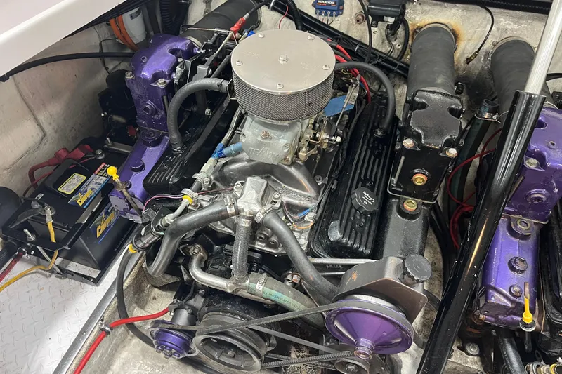 Slide: The Image of Engine compartment of a 1999 Donzi 28 ZX boat, featuring a powerful motor and battery setup. - 19