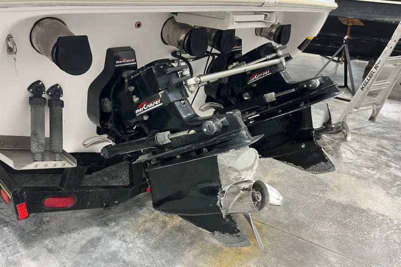 Slide: The Image of 1999 Donzi 28 ZX boat with dual MerCruiser outdrives in a garage setting. - 20