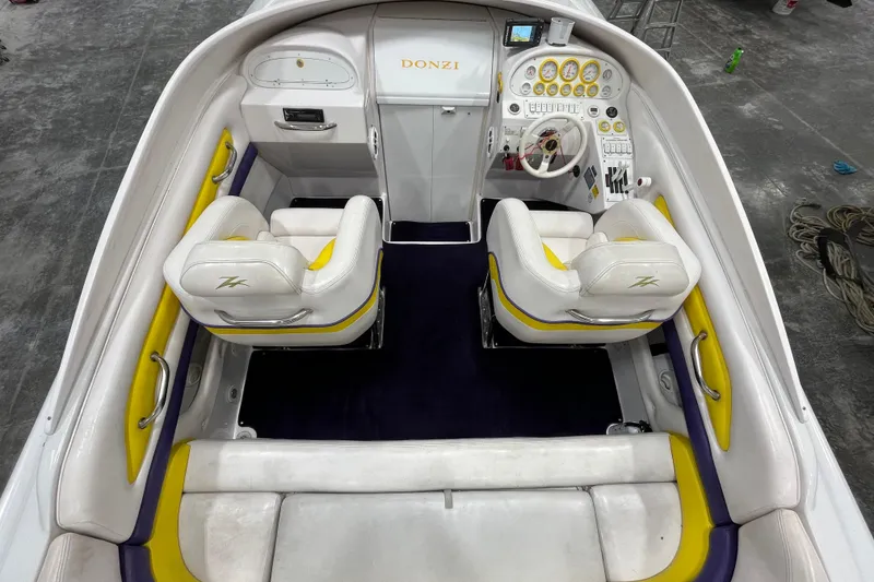 Slide: The Image of 1999 Donzi 28 ZX boat interior with white and yellow seating, detailed dashboard. - 9