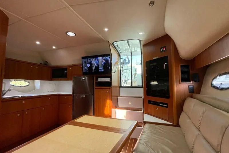 Slide: The Image of Interior of 2000 Tiara 41 Open yacht with kitchen, seating, and TV. - 10