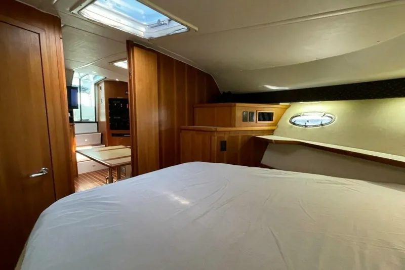 Slide: The Image of Interior of 2000 Tiara 41 Open yacht, featuring cozy cabin and wooden finishes. - 16