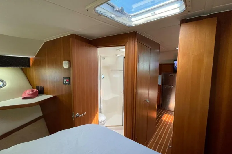 Slide: The Image of Interior of 2000 Tiara 41 Open yacht with wood paneling and skylight. - 18