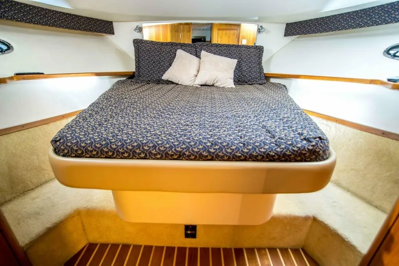 Slide: The Image of Luxurious cabin interior of 2000 Tiara 41 Open yacht with cozy bedding. - 2