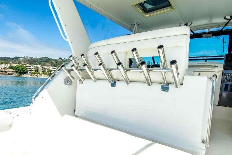 Slide: The Image of Tiara 41 Open 2000 yacht interior with rod holders, overlooking serene waterfront. - 21