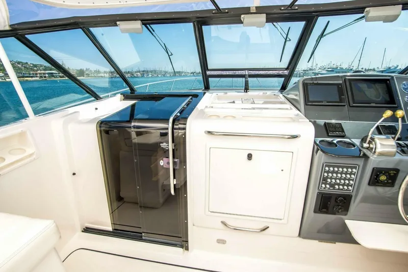 Slide: The Image of Cockpit of 2000 Tiara 41 Open yacht with modern controls and ocean view. - 24