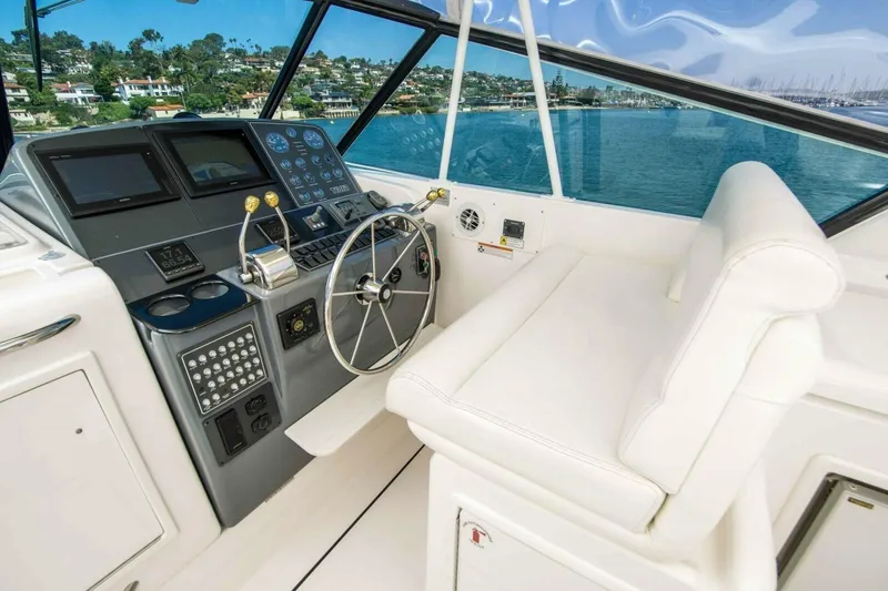 Slide: The Image of Helm of 2000 Tiara 41 Open yacht with modern controls and scenic ocean view. - 25