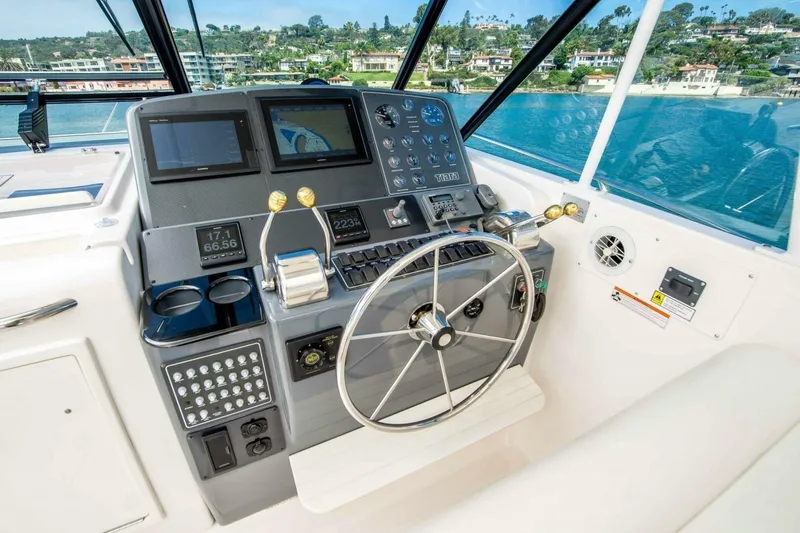 Slide: The Image of Helm of 2000 Tiara 41 Open yacht with navigation controls and steering wheel. - 26