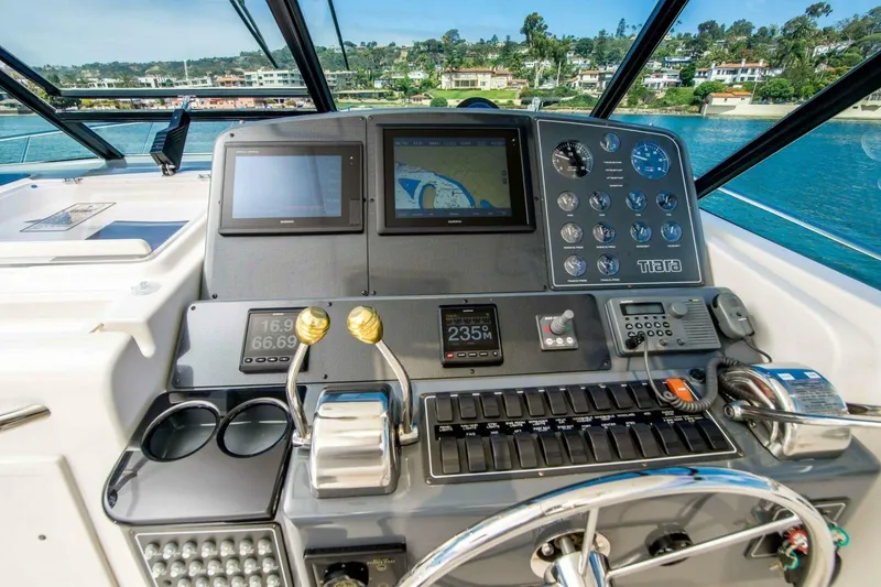 Slide: The Image of Cockpit of 2000 Tiara 41 Open yacht with navigation instruments and steering wheel. - 27