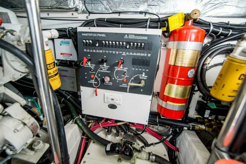 Slide: The Image of Engine room of 2000 Tiara 41 Open with control panel and fire extinguisher. - 29