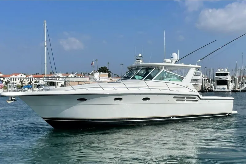 Slide: The Image of 2000 Tiara 41 Open yacht in marina, clear sky, calm water. - 32
