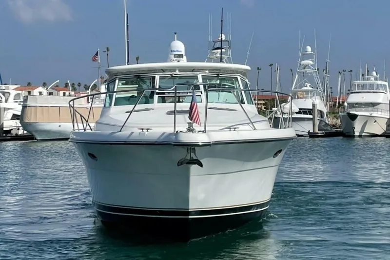 Slide: The Image of 2000 Tiara 41 Open yacht docked in marina, front view with clear sky. - 33