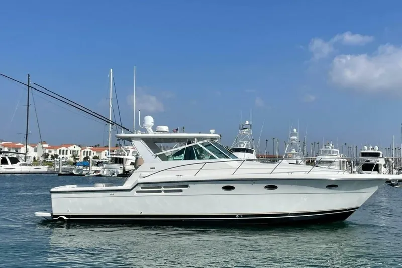 Slide: The Image of 2000 Tiara 41 Open yacht docked in marina under clear blue sky. - 36