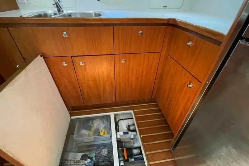 Slide: The Image of 2000 Tiara 41 Open yacht kitchen with wooden cabinets and storage compartment. - 8