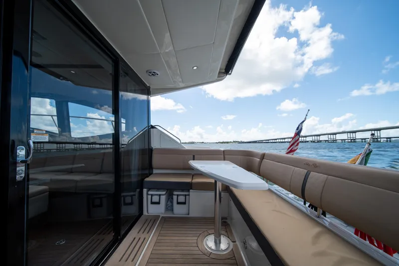 Slide: The Image of Luxury 2016 Sea Ray 400 Sundancer yacht interior with ocean view and seating area. - 11