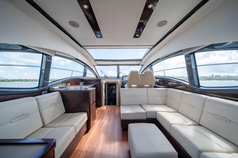 Slide: The Image of Luxurious interior of 2016 Sea Ray 400 Sundancer yacht with panoramic windows and plush seating. - 12