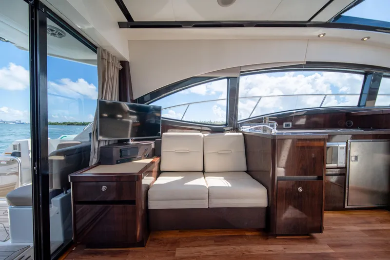 Slide: The Image of Luxurious interior of 2016 Sea Ray 400 Sundancer yacht with modern furnishings and scenic view. - 15